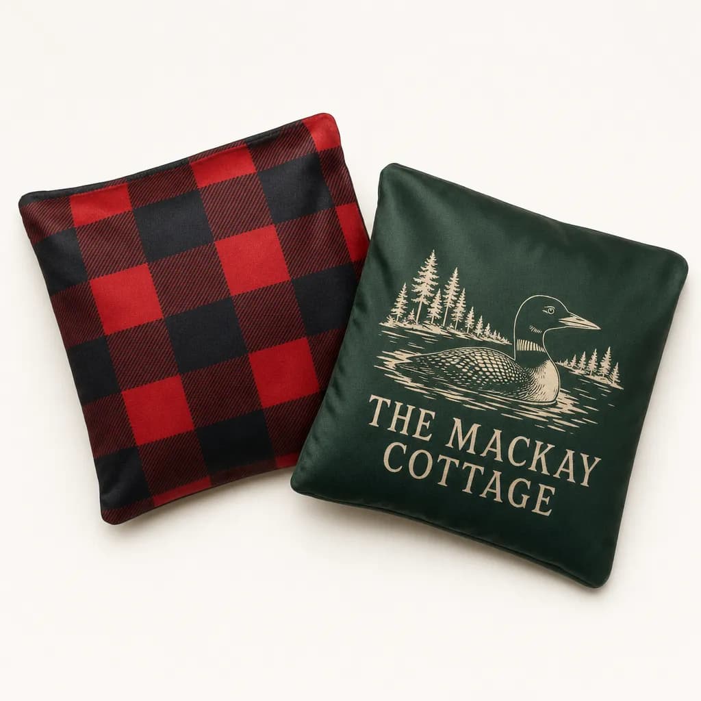 Buffalo plaid and green cottage cornhole bags with a loon illustration